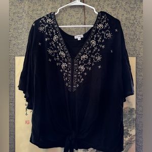 Eyeshadow brand. XXL. Sheer top, black with floral accent.